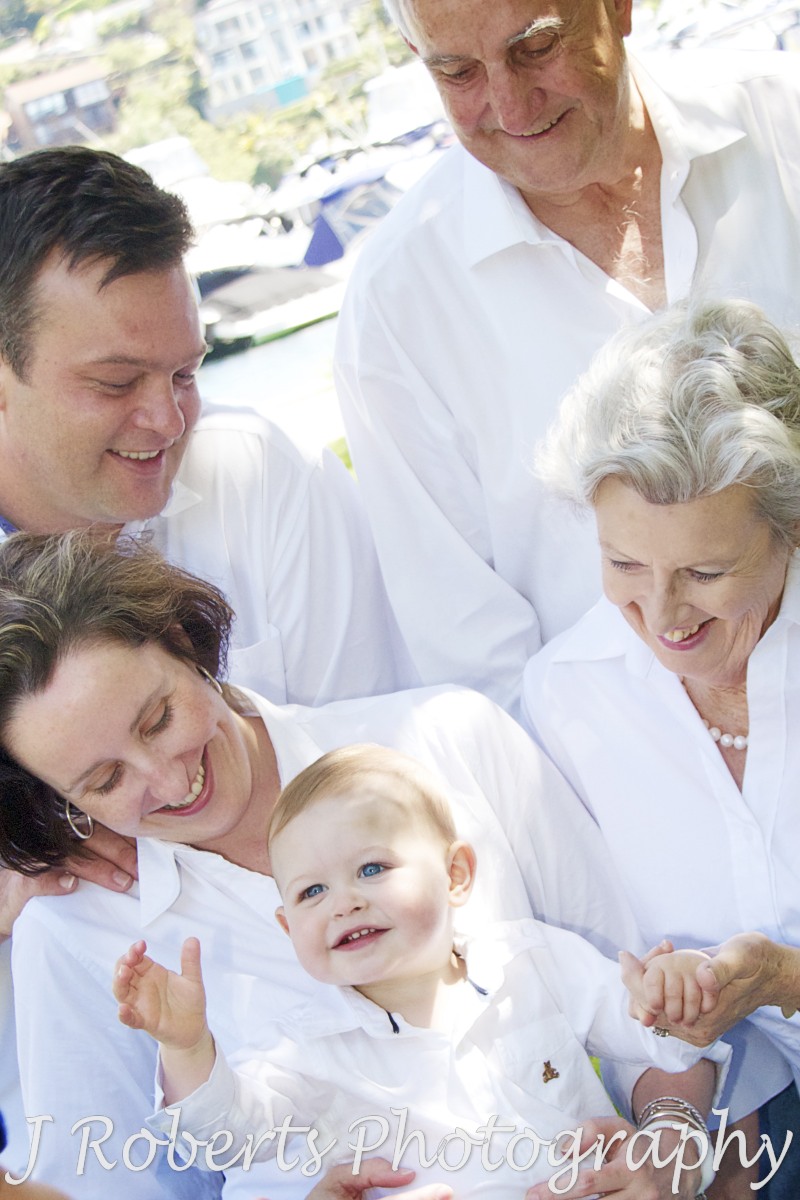 Parents and grandparents looking at laughing boy - family portrait photography sydney